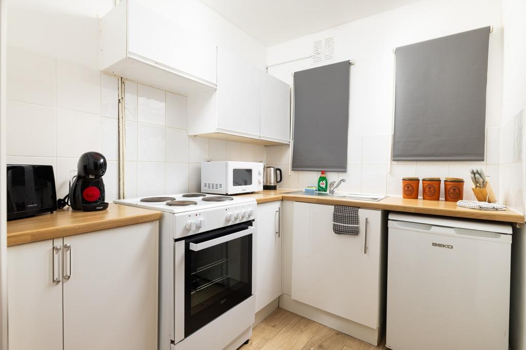 A bright and tidy kitchenette featuring modern ...