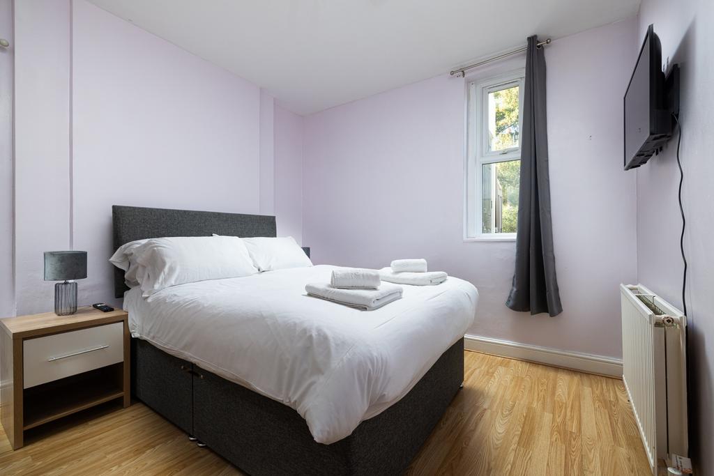 A spacious and inviting double bedroom with amp...