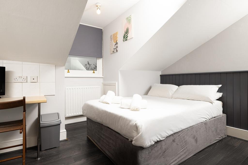 A bright and inviting double bedroom featuring ...