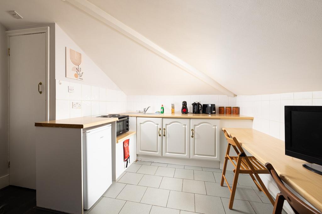 A bright and tidy kitchenette with modern appli...