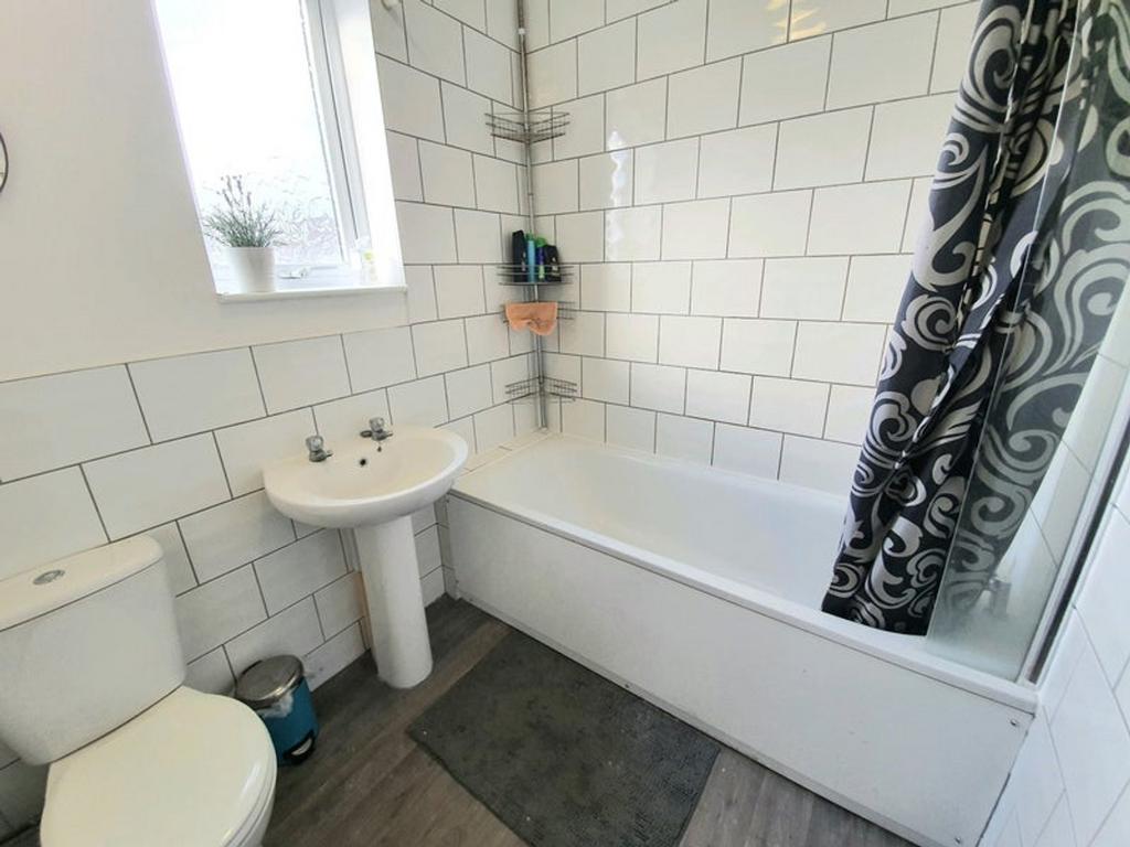 A bright and tidy bathroom featuring modern fix...