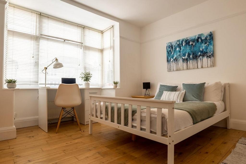 A bright and inviting double bedroom featuring ...