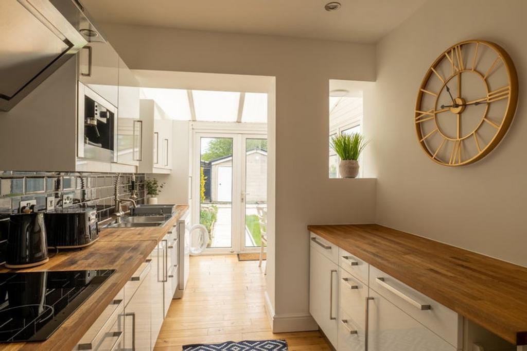 A bright and modern kitchen featuring stylish d...