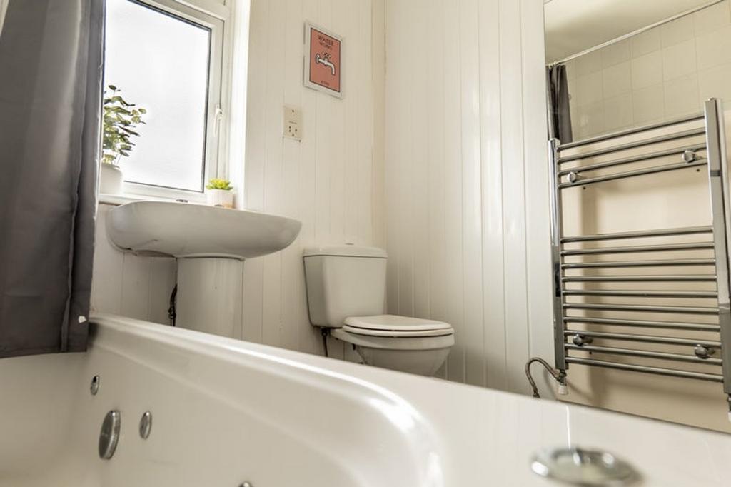 A bright and tidy bathroom featuring a stylish ...