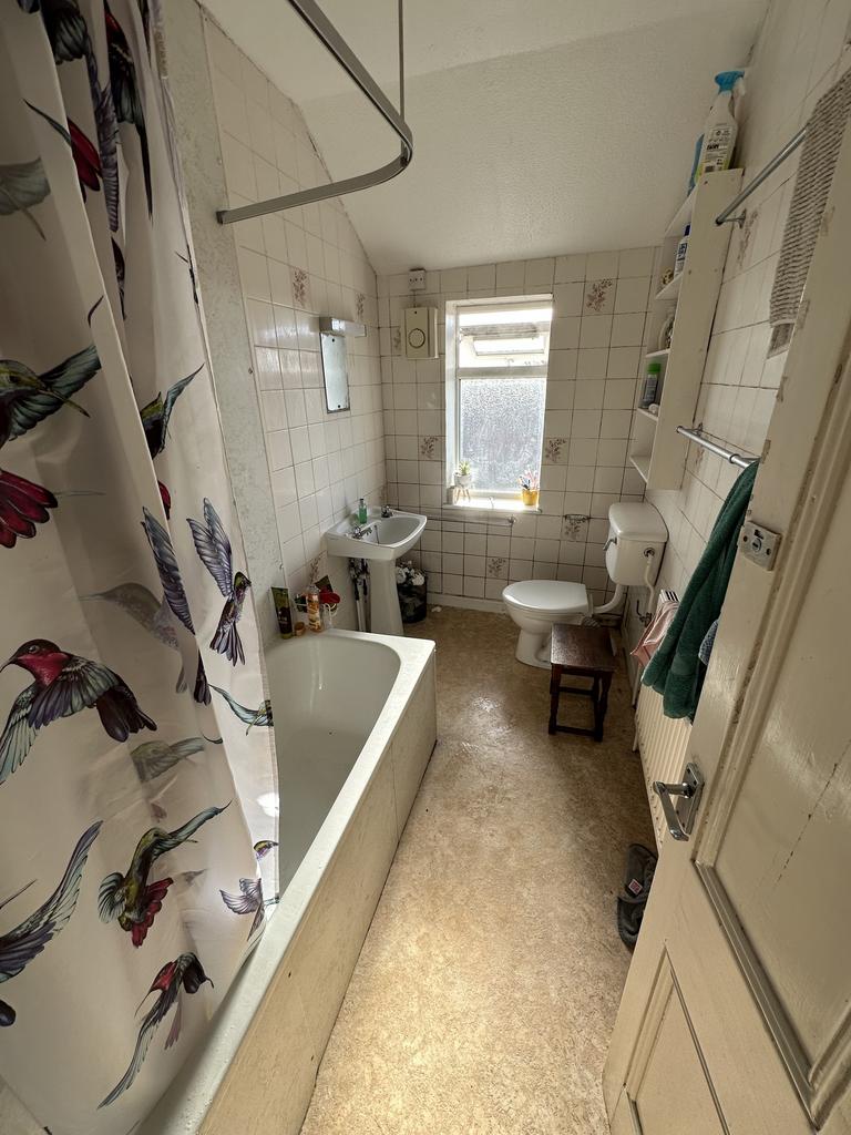 A tidy bathroom featuring a bath and natural li...