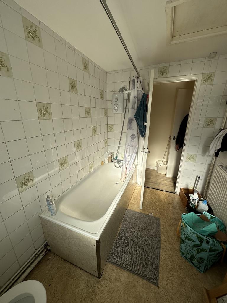 A bright and tidy bathroom featuring a comforta...