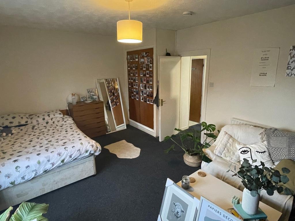 A spacious and inviting double bedroom with amp...