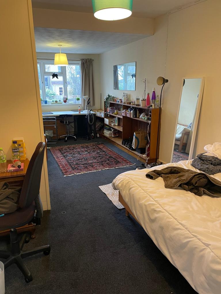 A spacious and well-lit double bedroom, perfect...