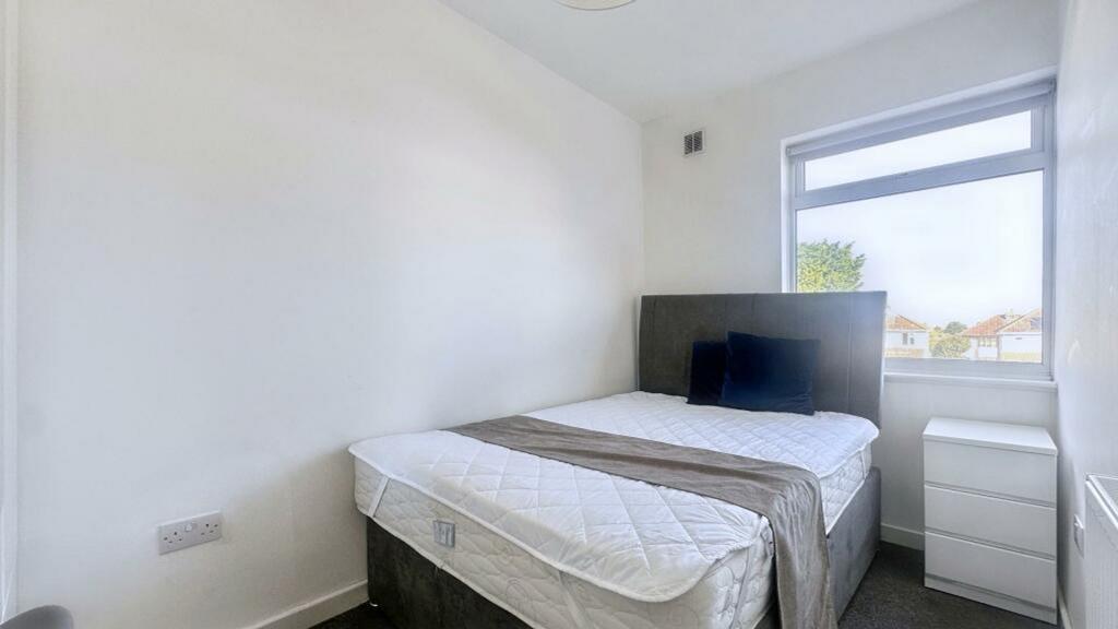 A bright and inviting double bedroom with ample...