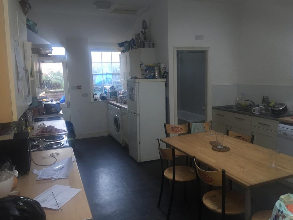A spacious kitchen with ample storage and natur...