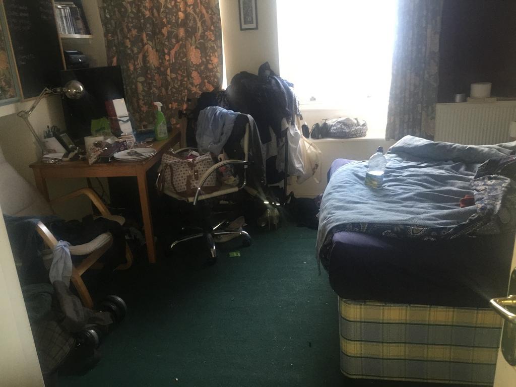 A cozy double bedroom with a personal touch, pe...