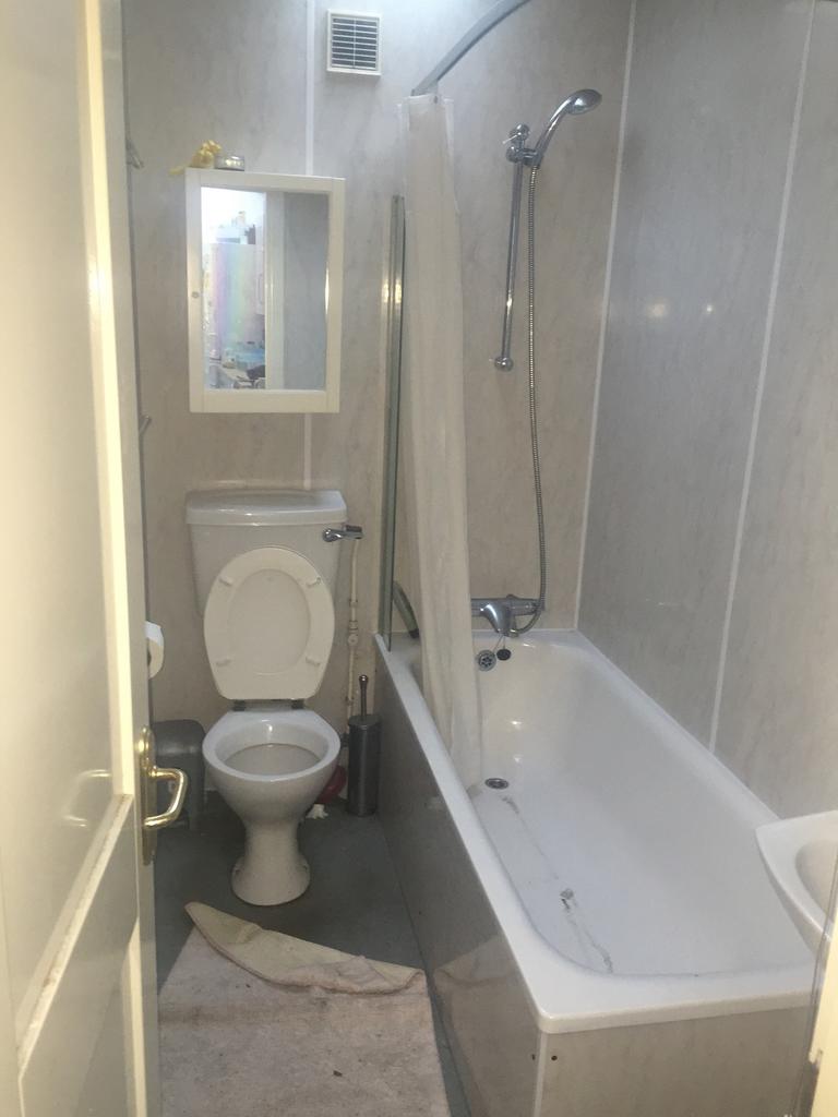 A functional bathroom featuring a bath and show...