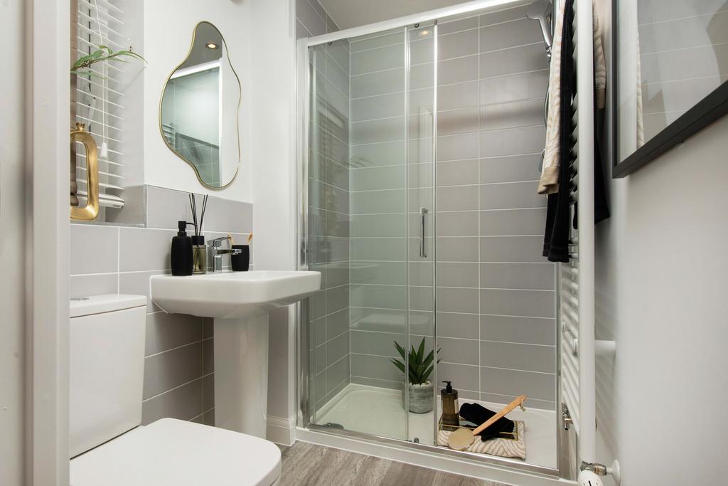 Grey tiled en suite shower room