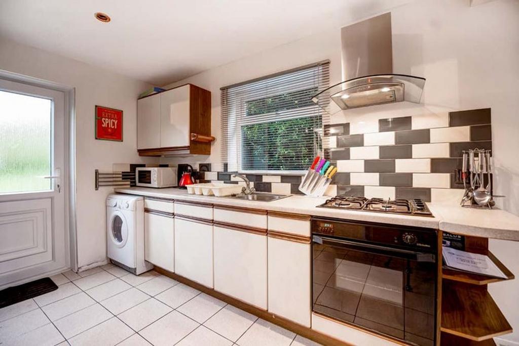 A bright and tidy kitchenette equipped with mod...