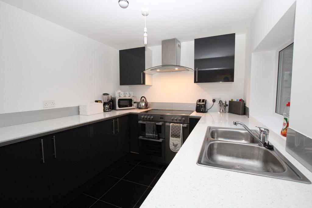 A modern and clean kitchen featuring sleek cabi...