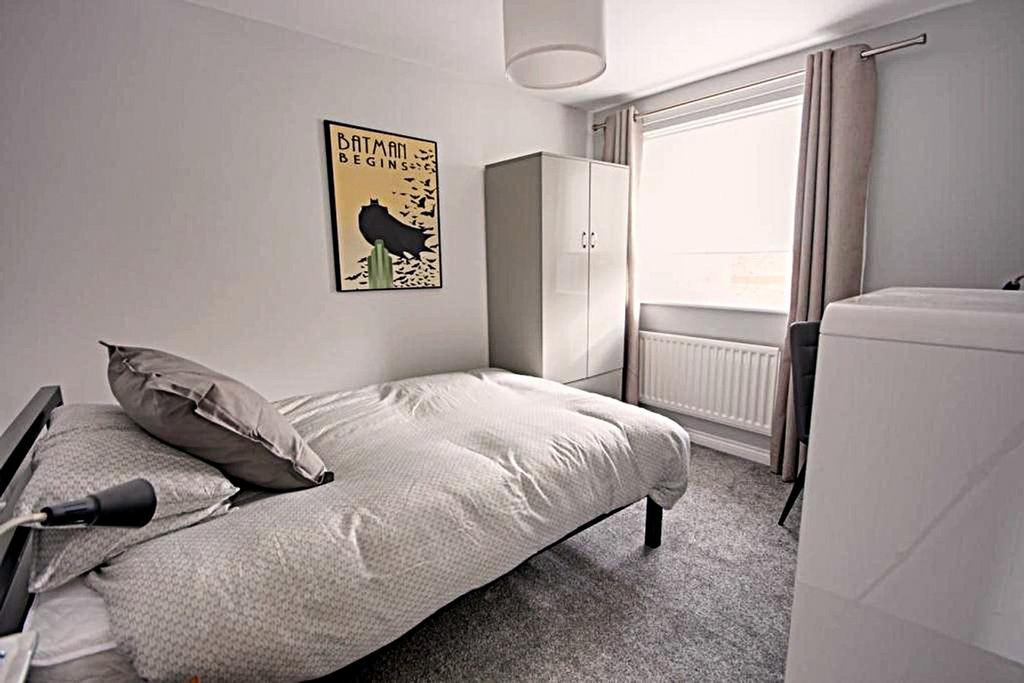 A bright and inviting double bedroom featuring ...