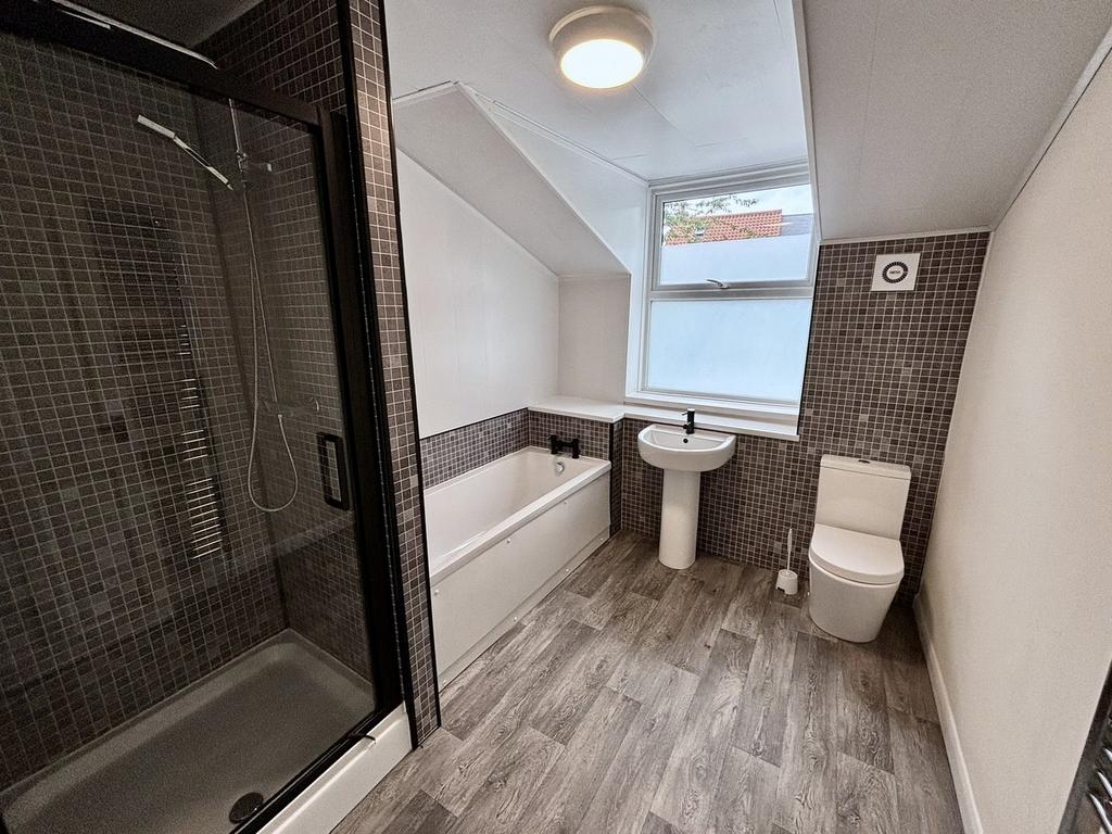 A spacious and modern bathroom featuring both a...