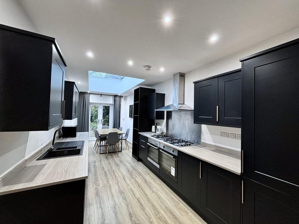 A modern and spacious kitchen featuring sleek b...