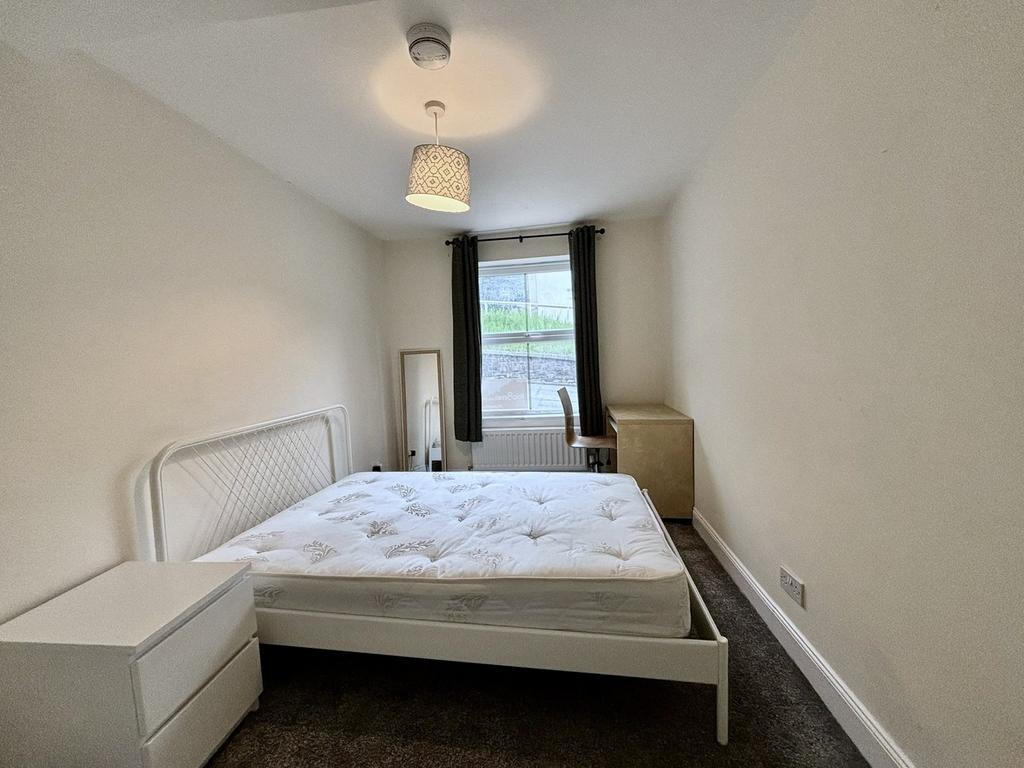 A spacious and bright double bedroom featuring ...