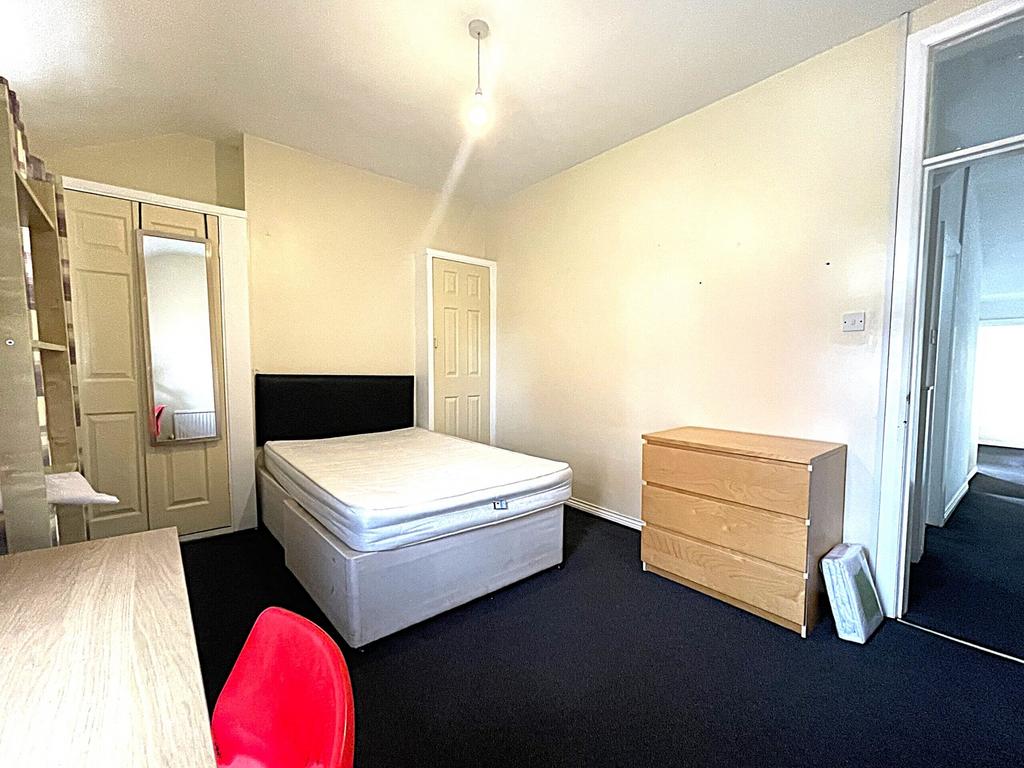 A bright and spacious double bedroom featuring ...