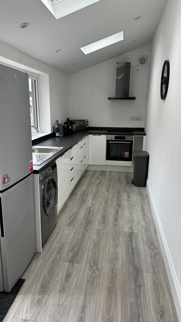 A modern and bright kitchenette featuring sleek...