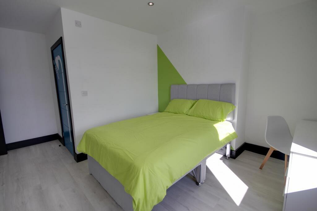 A bright and spacious double bedroom featuring ...