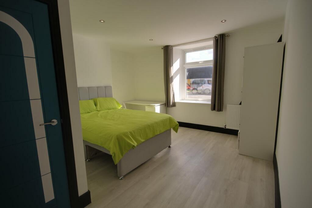A bright and spacious double bedroom featuring ...
