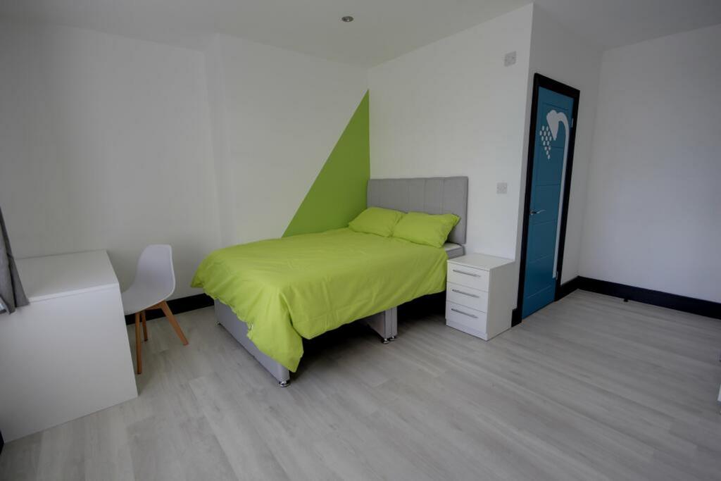 A spacious and bright double bedroom featuring ...