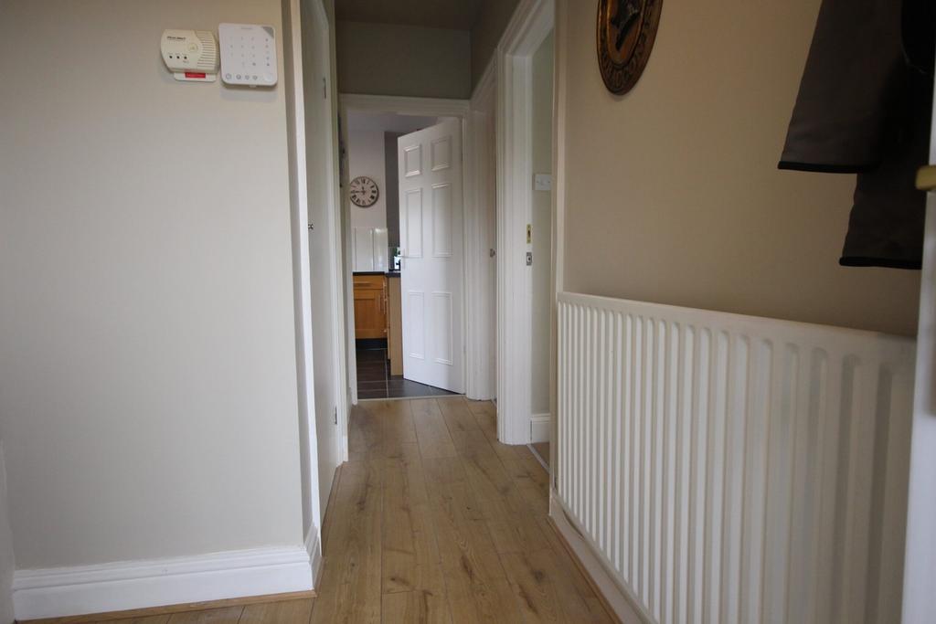 A clean and inviting hallway leading to various...