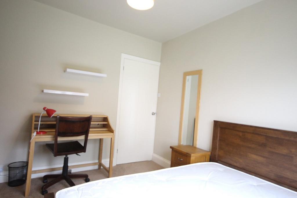 A bright and tidy double bedroom featuring a wo...