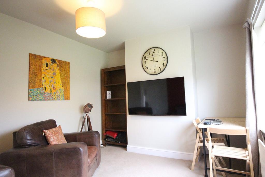 A bright and inviting living room featuring com...