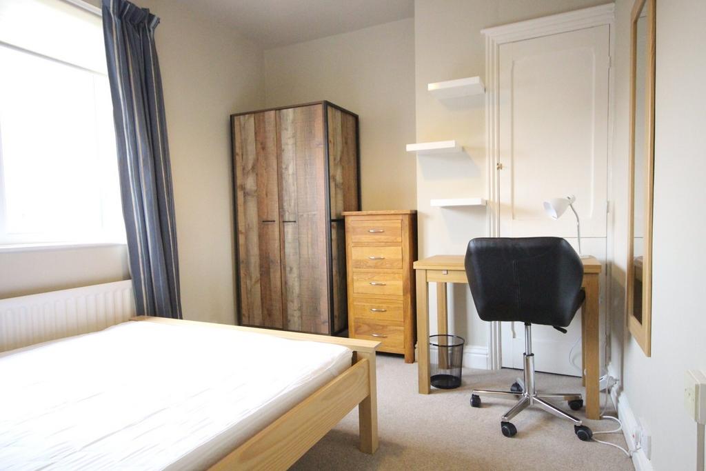 A bright and tidy double bedroom featuring a co...