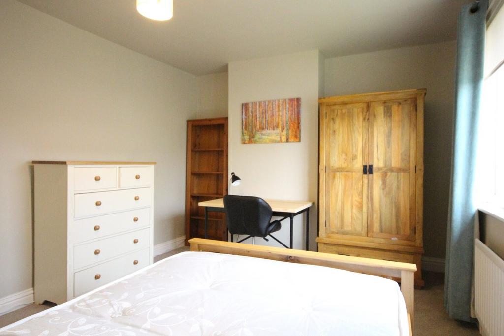 A bright and inviting double bedroom, featuring...