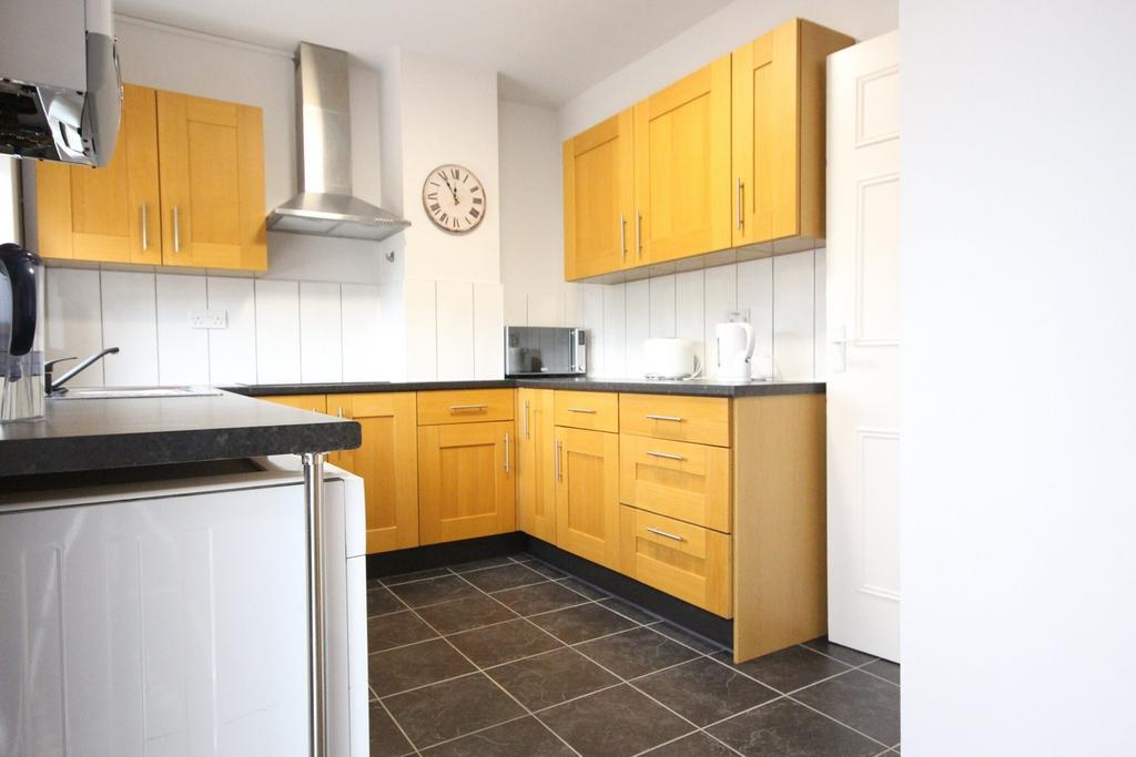 A bright and tidy kitchenette with modern cabin...
