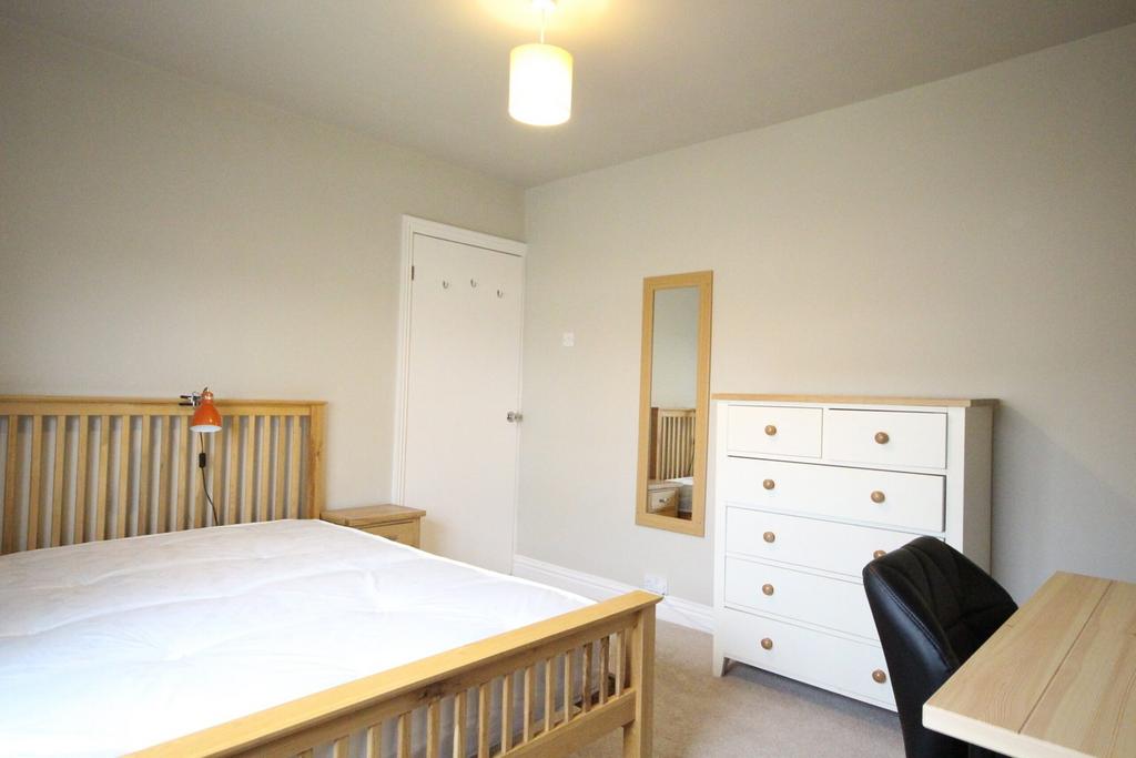 A bright and inviting double bedroom featuring ...