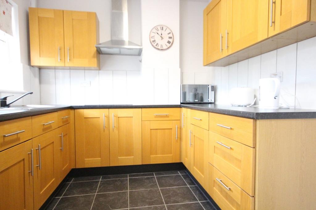 A bright and tidy kitchen featuring modern wood...