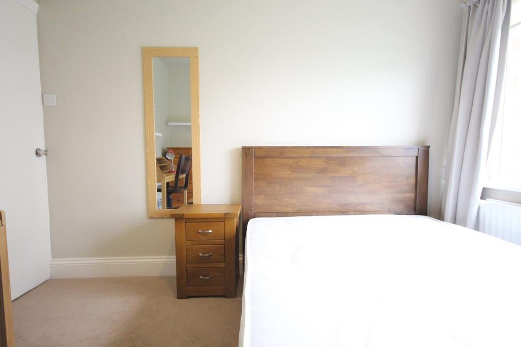 A bright and tidy double bedroom featuring a co...