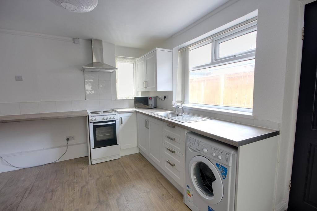 A bright and modern kitchenette featuring essen...