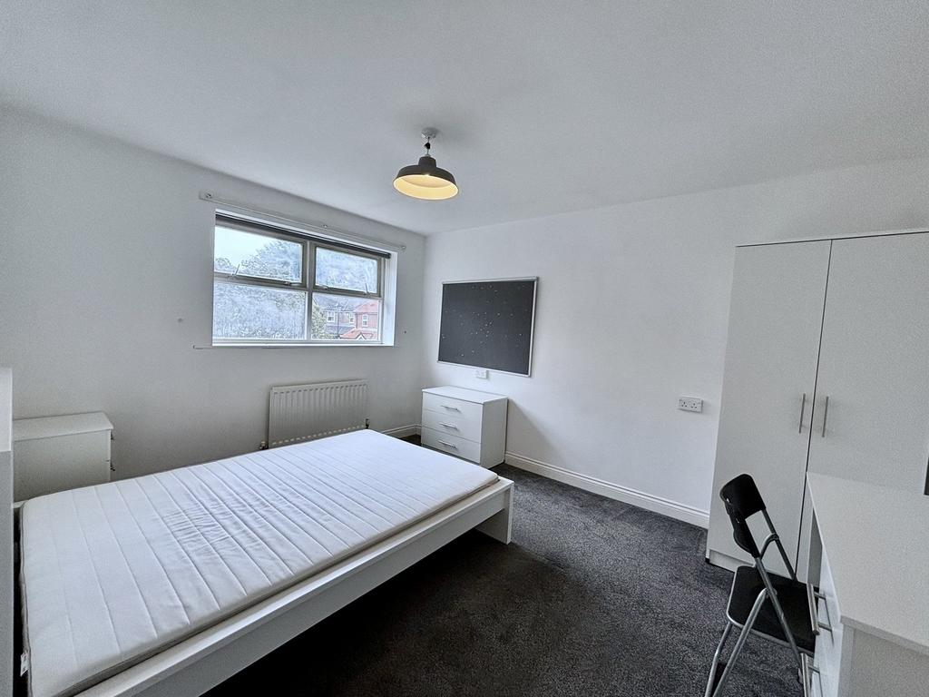 A bright and spacious double bedroom featuring ...
