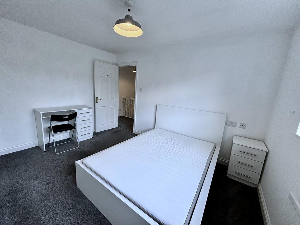 A bright and tidy double bedroom with modern fu...