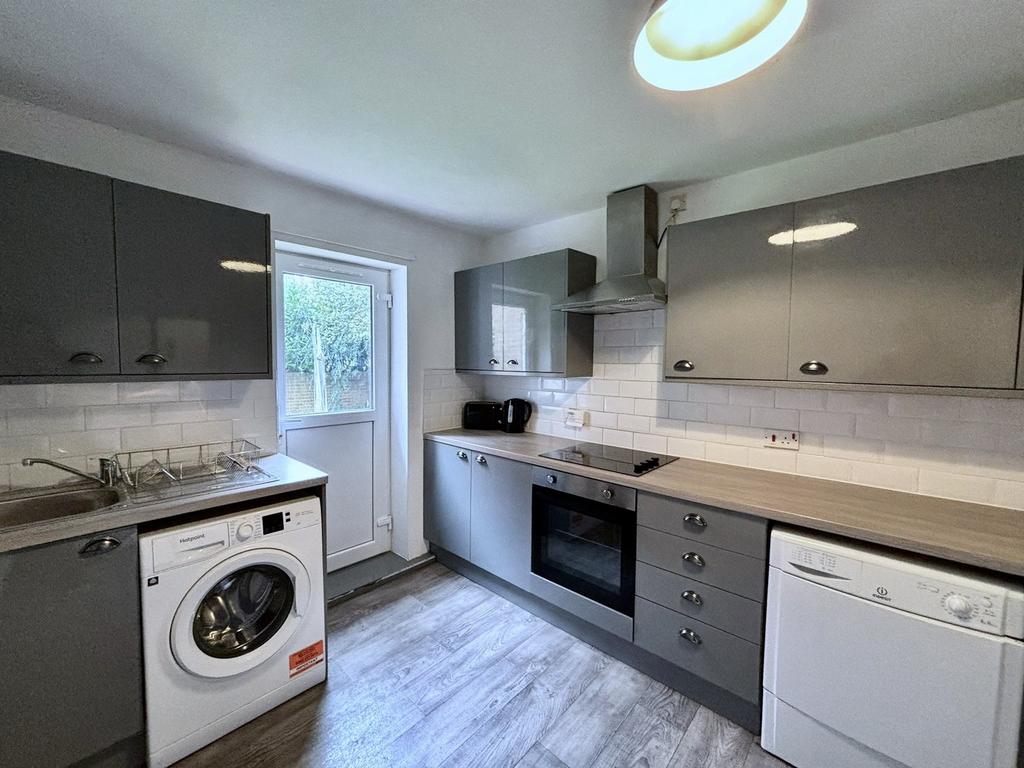 A modern and tidy kitchen featuring ample stora...