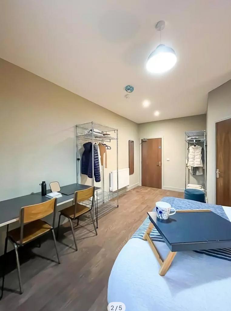 A spacious and well-lit double bedroom featurin...