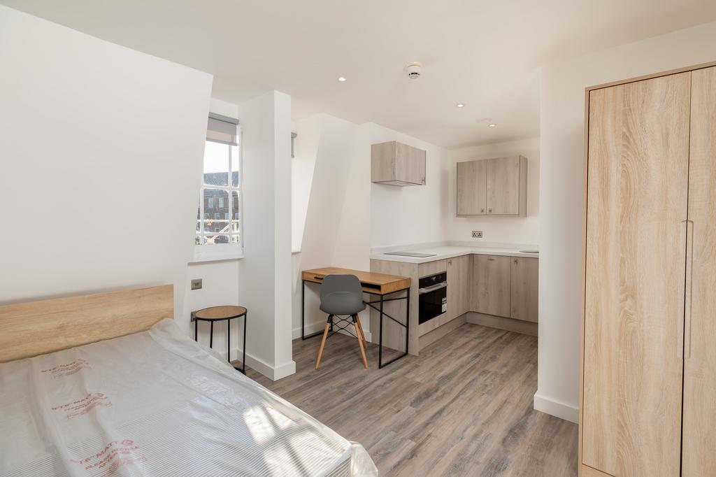 A modern and spacious kitchenette area with amp...
