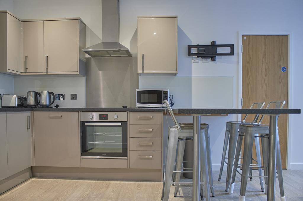 A modern and clean kitchenette with ample stora...