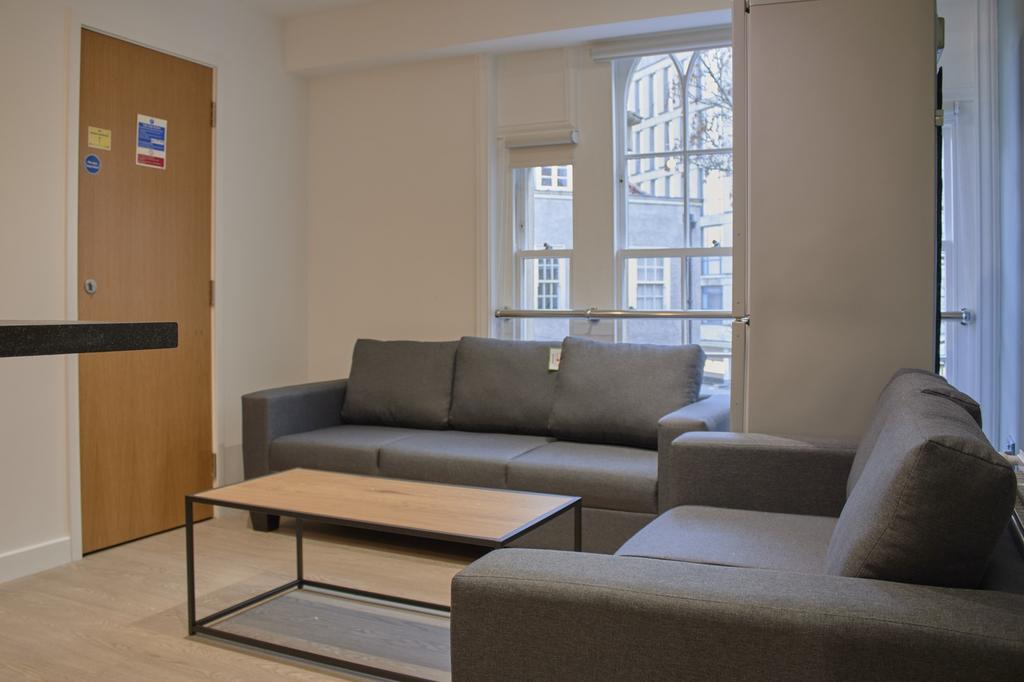 A spacious and modern living room featuring com...