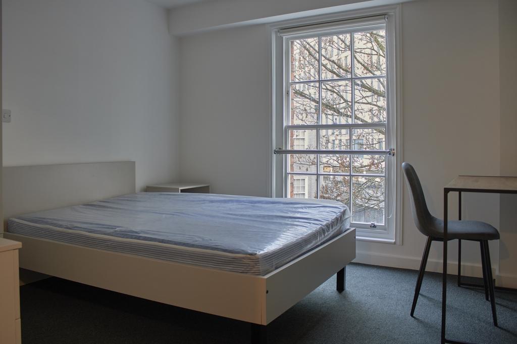 A bright and tidy double bedroom featuring a co...