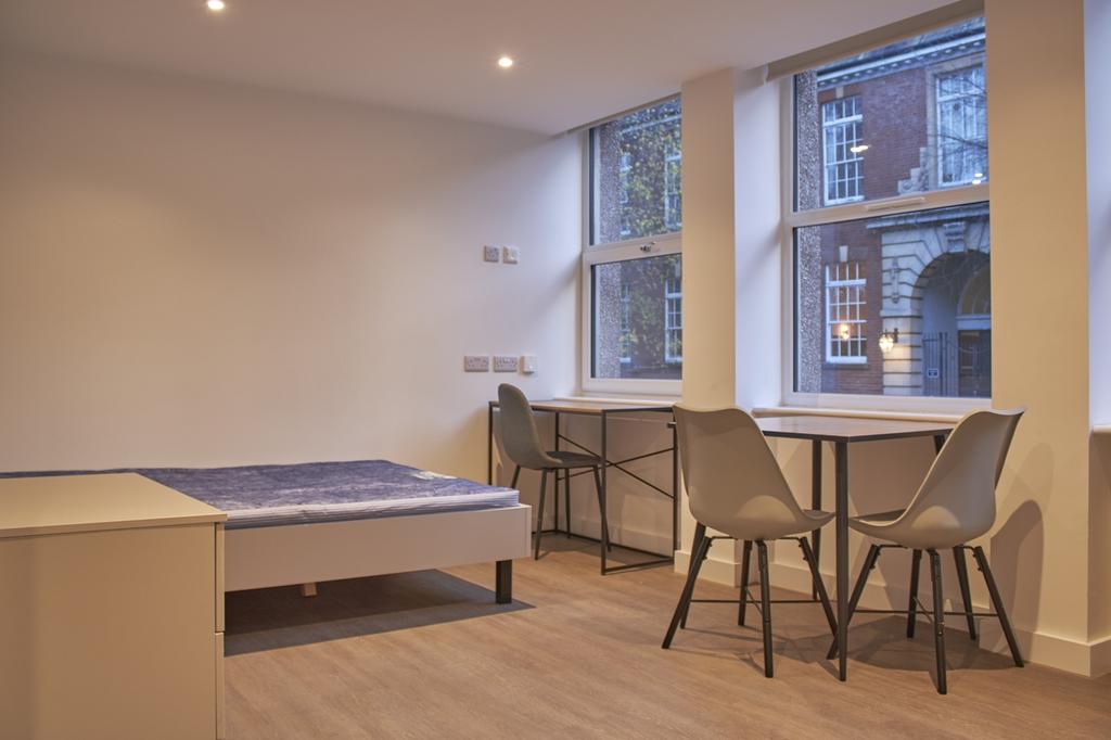 A bright and spacious double bedroom with moder...