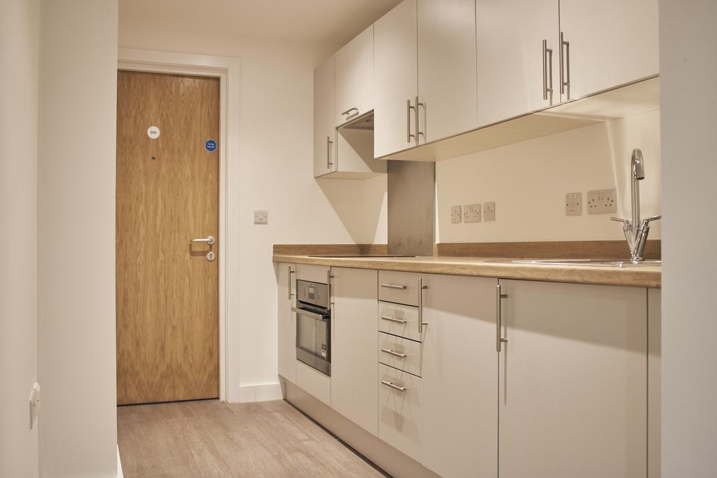 A modern and tidy kitchenette featuring sleek c...