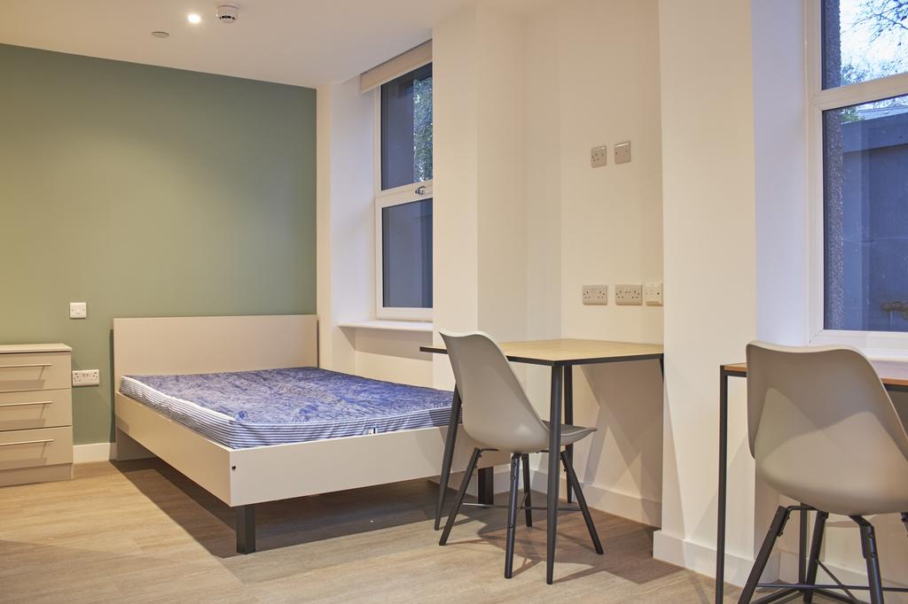 A bright and modern double bedroom featuring a ...