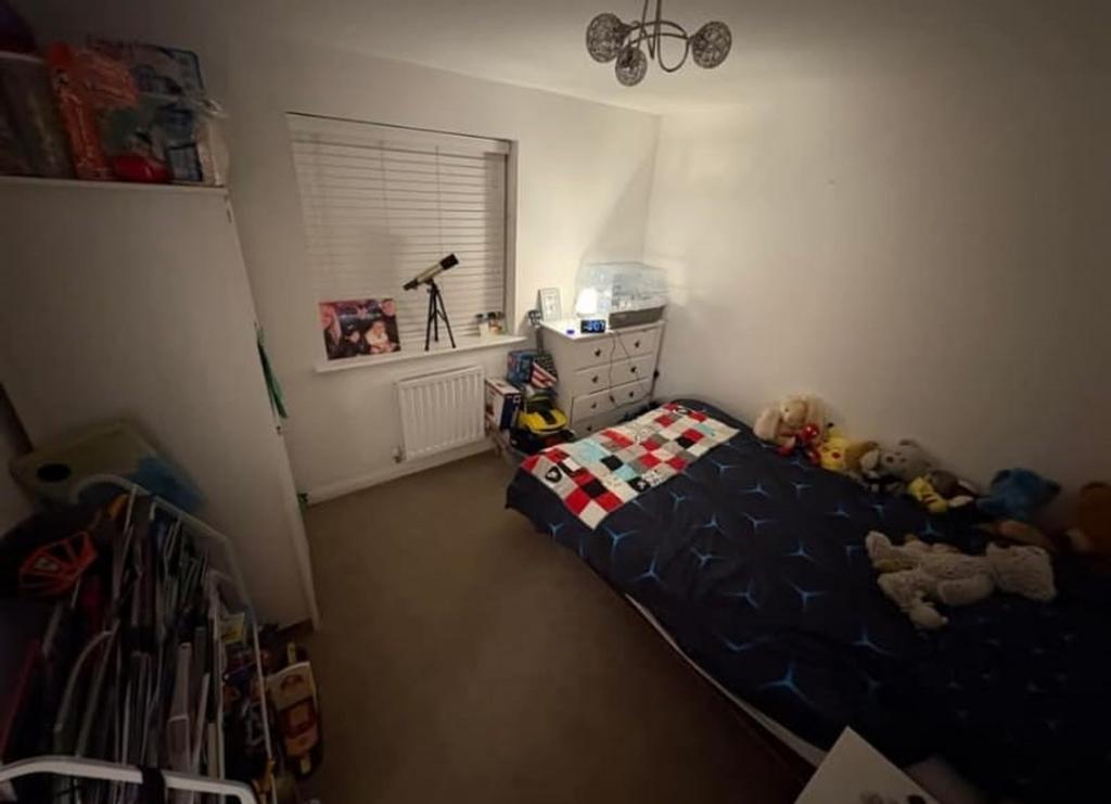 A cozy double bedroom with personal touches, pe...